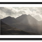 a framed fine art photograph of A dramatic view of the eastern edge of The MacGillycuddy's Reeks, Ireland's highest mountain range with the peak of Cruach Mhor visible against a bright cloudy sky