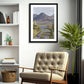 a framed fine art photograph of Diamond Hill mountain in Connemara as seen from Derryinver Peninsula hanging on a wall above a chair in a living room