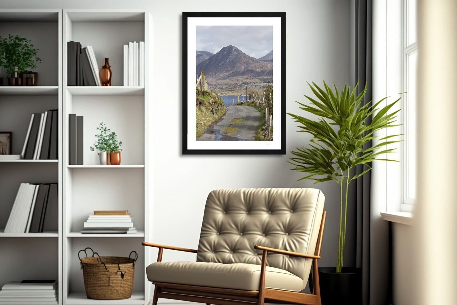 a framed fine art photograph of Diamond Hill mountain in Connemara as seen from Derryinver Peninsula hanging on a wall above a chair in a living room