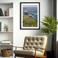 a framed fine art photography of the stunning view of the Crohy coastline and Donegal landscape from Crohy Head hanging on a white wall above a beige chair in a living room