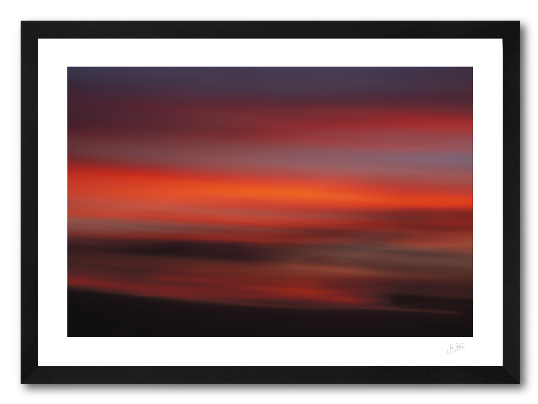 a framed intentional camera movement fine art photographic print of clouds in a red twilight sky above the island of Lanzarote, Canary Islands