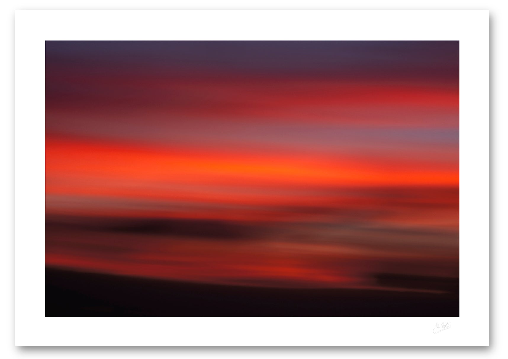 an intentional camera movement fine art photographic print of clouds in a red twilight sky above the island of Lanzarote, Canary Islands