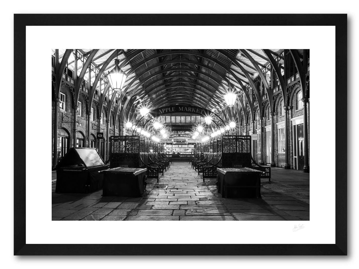 a framed black and white fine art photographic print of the Apple Market in Covent Garden, London, England, after the market has closed, available to buy online 