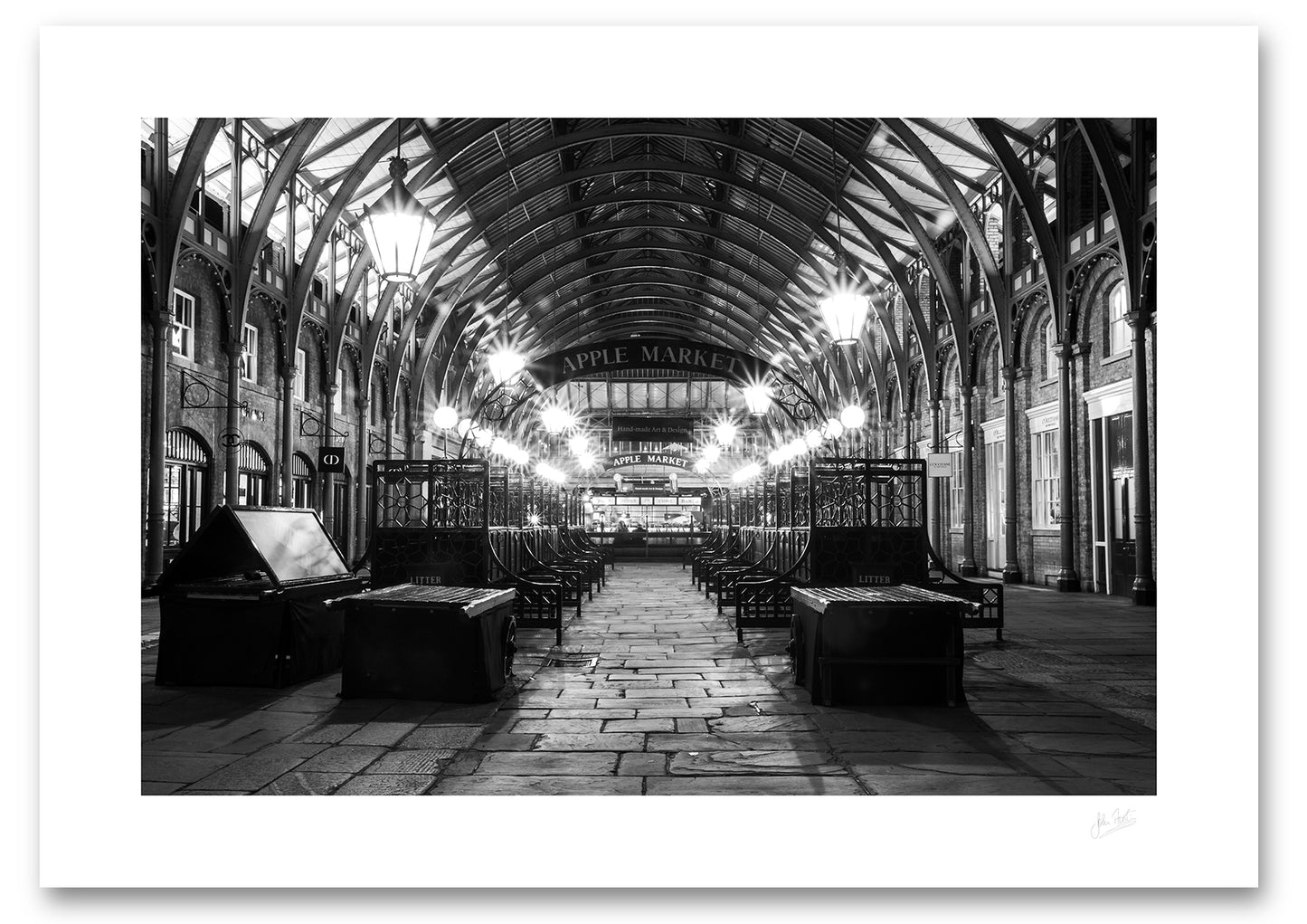 an unframed black and white fine art photographic print of the Apple Market in Covent Garden, London, England, after the market has closed, available to buy online