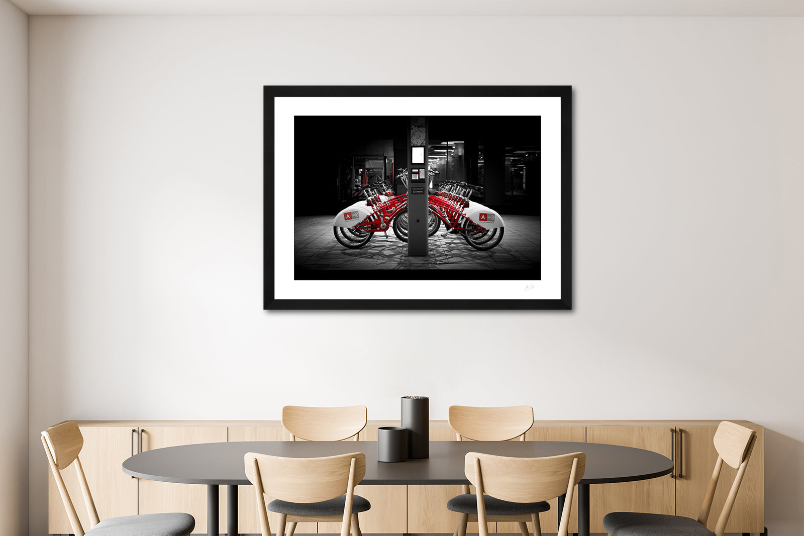 a framed fine art photographic print of rental bikes on a bike rack outside Antwerp Central Train Station, on a dining room wall