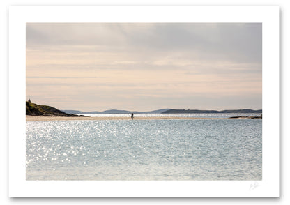 an unframed fine art photographic print of a young woman taking a leisurely stroll along a quiet Glassilaun Beach in Connemara, Ireland on a beautiful summer afternoon, available to buy online